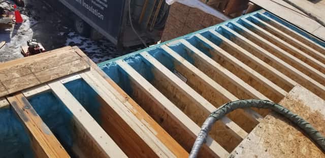 The underside of a floor structure sealed with spray foam