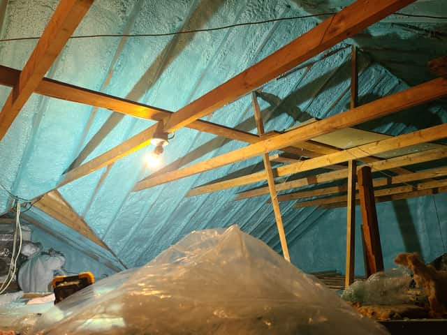 Spray foam applied between roof rafters, sealing the underside of the roof deck