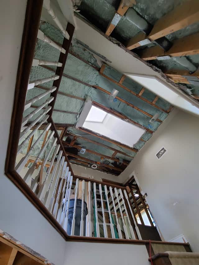 Closed-cell spray foam filling the stud cavities of a framed interior wall
