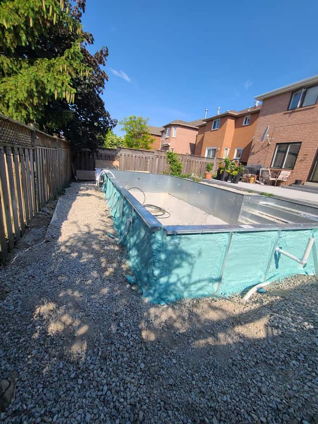 A pool shell insulated with spray foam before backfilling