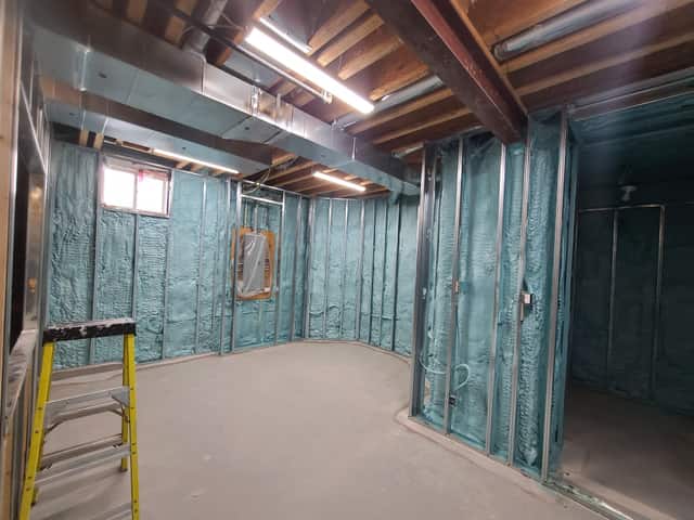 Closed-cell spray foam filling the stud cavities of a framed interior wall