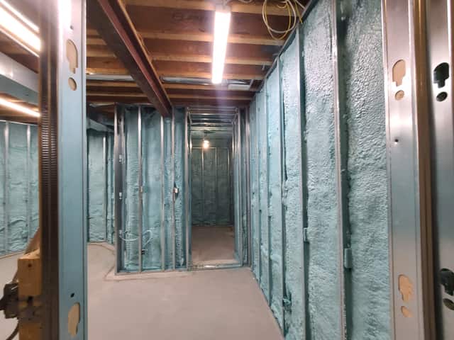 Closed-cell spray foam filling the stud cavities of a framed interior wall