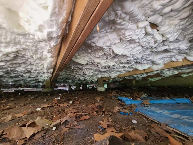 A crawl space ceiling sealed with expanding spray foam