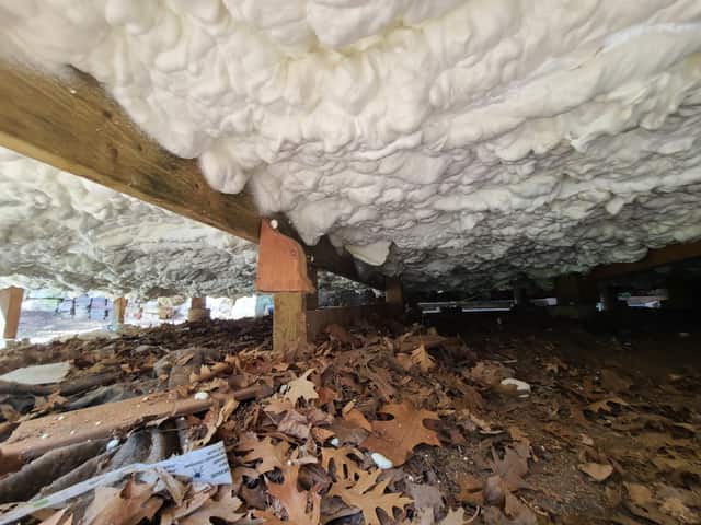 A crawl space ceiling sealed with expanding spray foam
