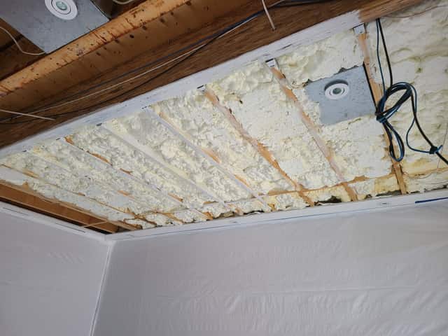 The underside of a floor structure sealed with spray foam