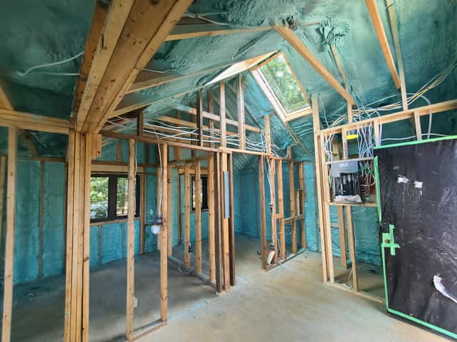 Spray foam applied between roof rafters, sealing the underside of the roof deck