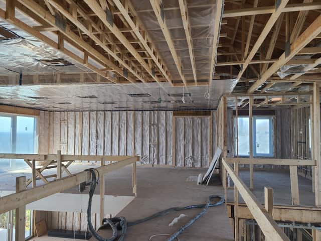 Closed-cell spray foam filling the stud cavities of a framed interior wall