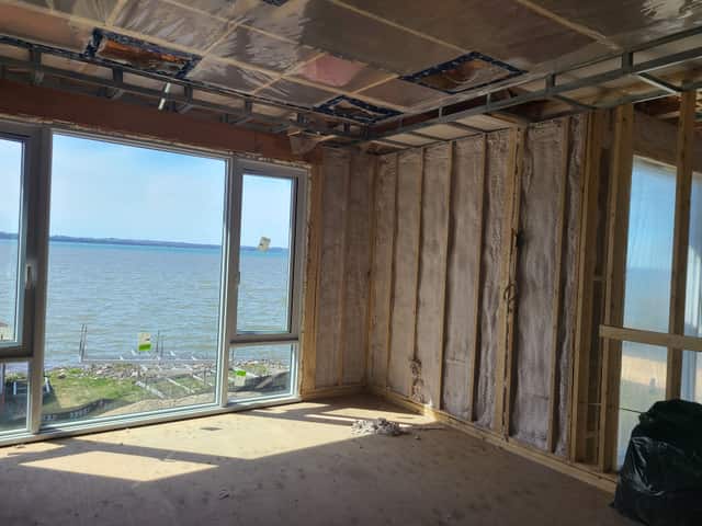 Closed-cell spray foam filling the stud cavities of a framed interior wall