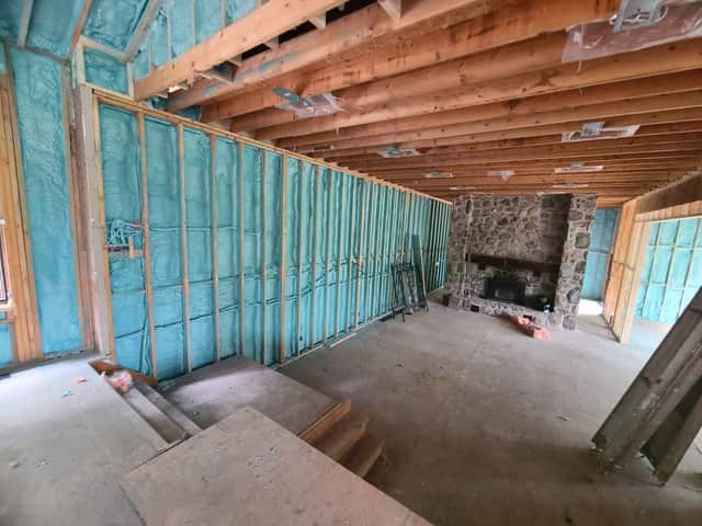 Closed-cell spray foam filling the stud cavities of a framed interior wall