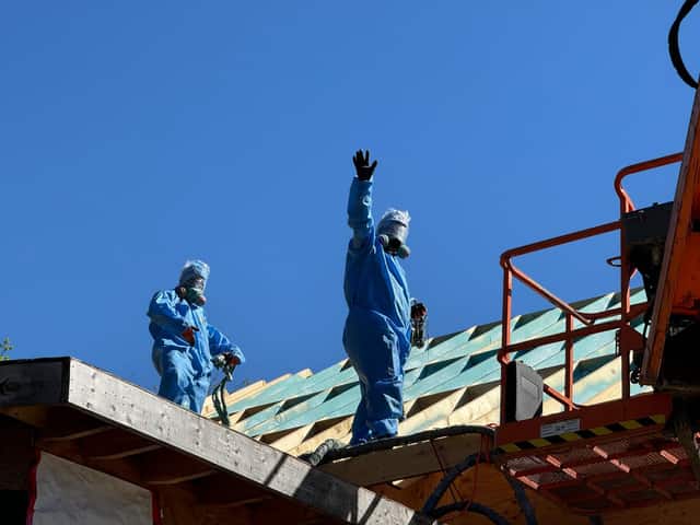 Fahrenheit Foam crew in full protective suits and respirators spraying foam on a roof