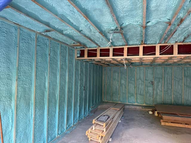 Closed-cell spray foam filling the stud cavities of a framed interior wall