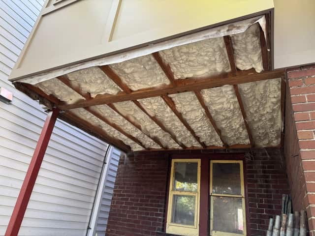The underside of a floor structure sealed with spray foam